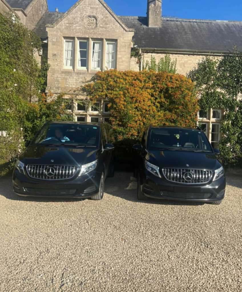 Private hire vehicles outside a stone building