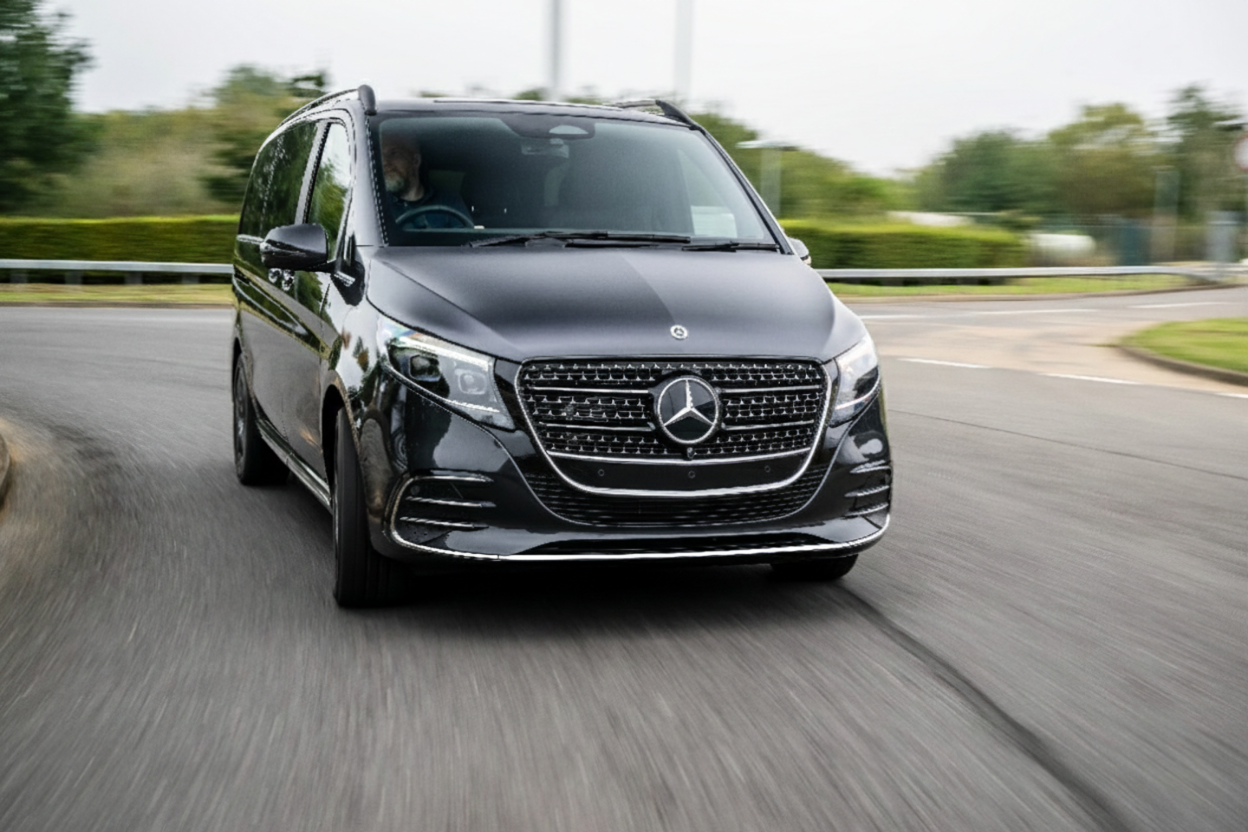 Black executive people carrier on the road